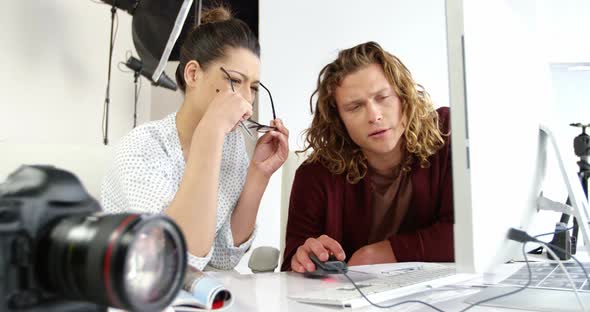 Photographers having discussion on personal computer alt
