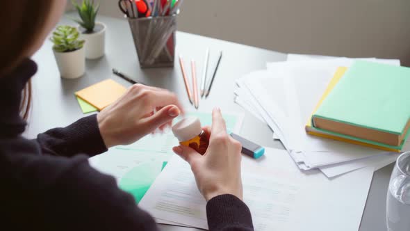 Close Up of Woman Office Worker Taking Her Medication During the Working Day