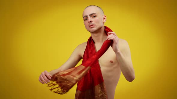Young Caucasian Male Naked Queer Posing with Red Scarf at Yellow Background alt