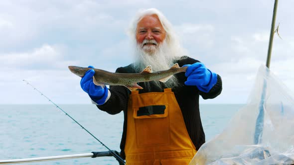 Fisherman holding fish alt