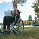 Thumbs Up, Remote Work Concept. Young Disabled Woman in the Wheelchair Using Smartphone and Laptop - VideoHive Item for Sale
