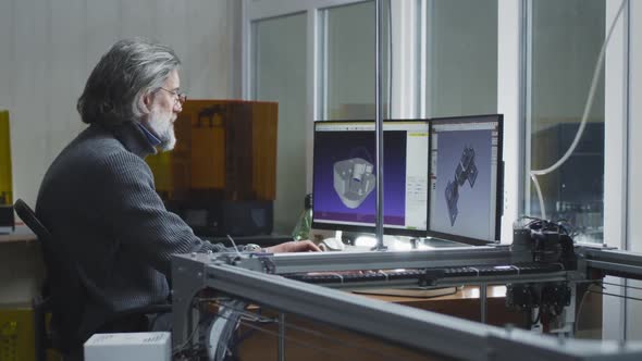 Middle Aged Designer Using Computer Near Colleague alt