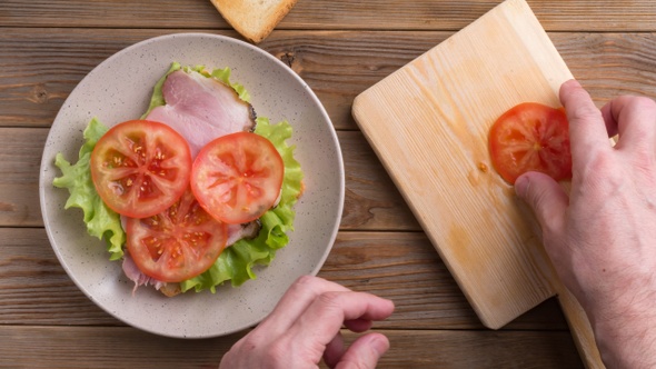 Making and Eating Sandwich with Tomato, Ham, Cheese and Salad