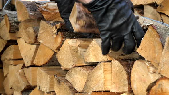 A Mans Hand Grabbing Some Firewoods From the Storage alt