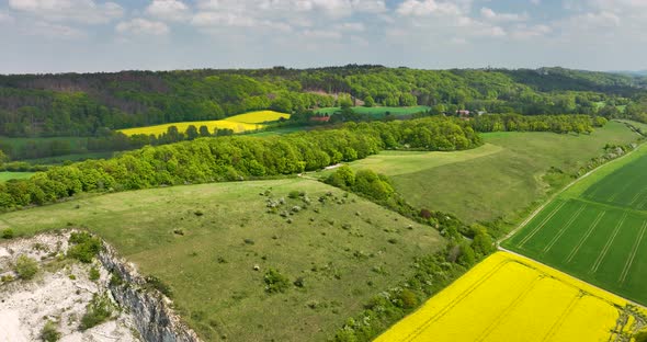 Aerial view of rapeseed field and hillside of Teutoburger Wald, Germany alt
