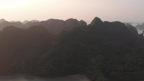 Aerial: unique flying over Ha Long Bay and Cat Ba island at sunset, famous tourism destination in Vi alt