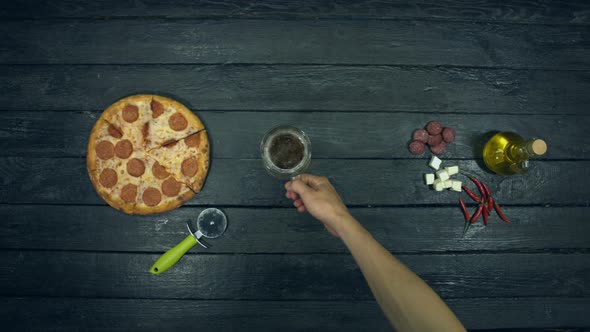 Beer and Pepperoni Pizza on Ecological Black Background.