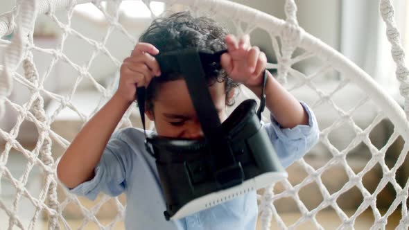 Little African Kid Putting on VR Goggles