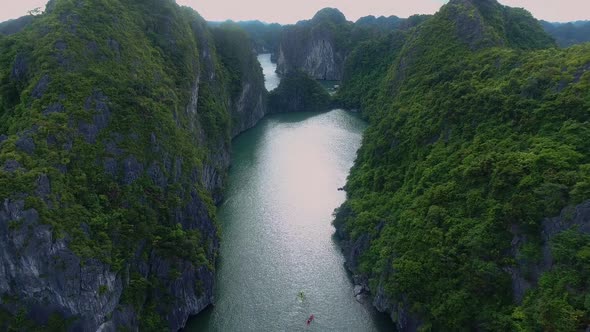 Tiny Kayak Swimming In The Gigantic Bay -  Ha Long - Vietnam