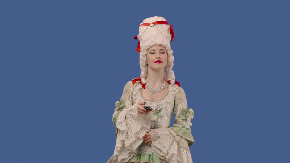Portrait of Courtier Lady in White Vintage Dress and Wig Watching TV and Changing Channels Using alt