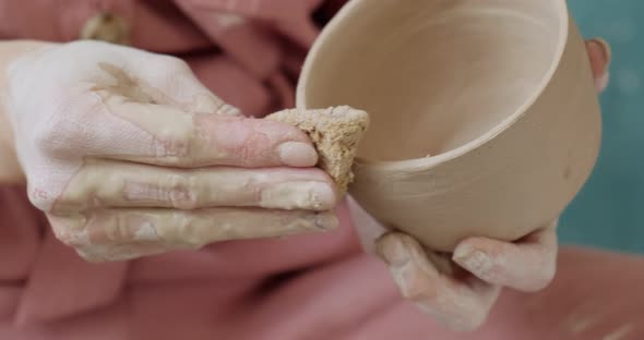 Female Potter Sitting and Makes a Cup. Woman Making Ceramic Item. Pottery Working, Handmade and alt