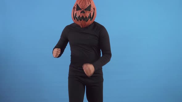 Dancing Pumpkin Man on a Blue Background alt