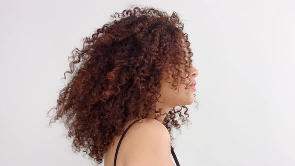 Mixed Race Black Woman with Freckles and Curly Hair in Studio in Profile To a Camera