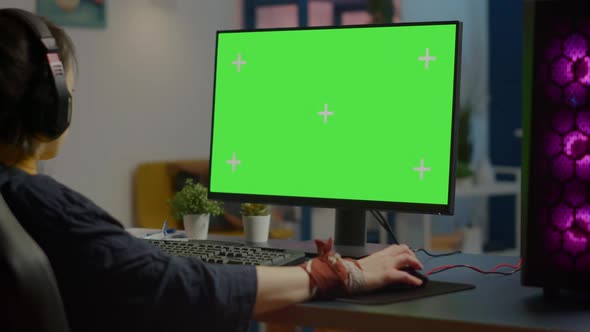 Woman Streaming Online Video Games on Powerful Computer with Green Screen alt