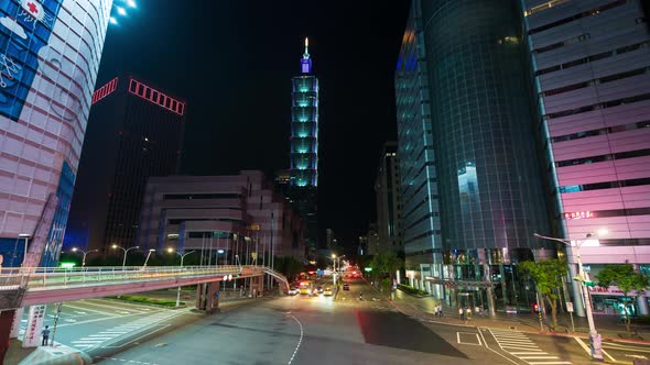 time lapse of Taipei 101 tower with traffic on road at night in Taipei, Taiwan alt