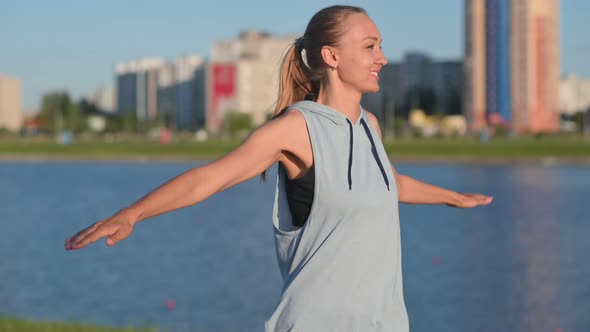Young fit girl athlete warming up before jogging outdoors	