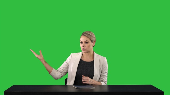 Television anchorwoman at studio pointing to sides on a alt