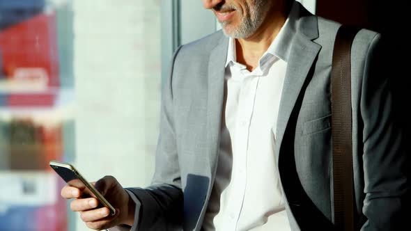 Businessman using mobile phone in hotel room 4k alt