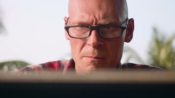Portrait of handsome man working on laptop outdoor