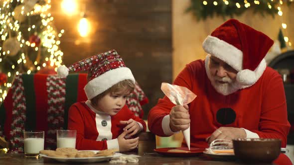 Grandfather and Grandson Cooks a Cake in the Kitchen on Christmas Day. Prepare Xmas and New Year