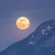 Big Golden Full Moon Rising over Alpine Mountains Peak in Winter Evening - VideoHive Item for Sale