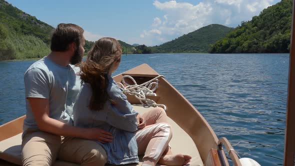 Couple Enjoying a Motor Boat Ride on the Lake on a Sunny Day