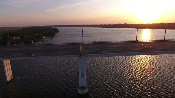 Aerial Shot of a Big Bridge at Pink Sunset From a Drone Moving Along in Summer