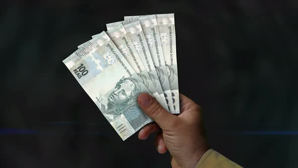 Brazil Real, Reai money fan of banknotes in hand alt