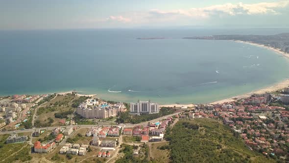 Aerial view of Sunny Beach city that is located on Black Sea shore. Top view of sand beaches with alt