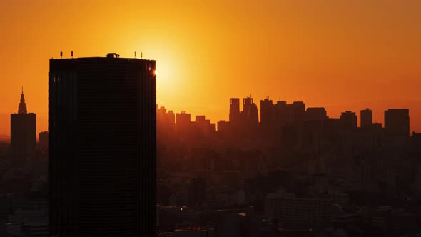 Timelapse aerial view of Tokyo skylines and skyscrapers buildings in Shinjuku at sunset, Japan  alt