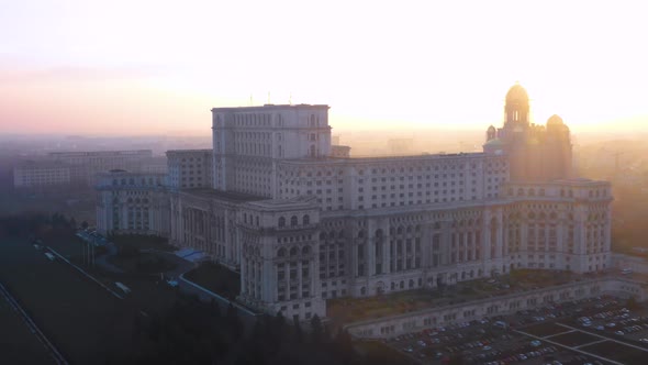 Sunset Drone Shot Of The Palace Of The Parliament in Bucharest, Romania  alt