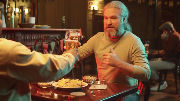 Man Greeting His Friend In Pub alt