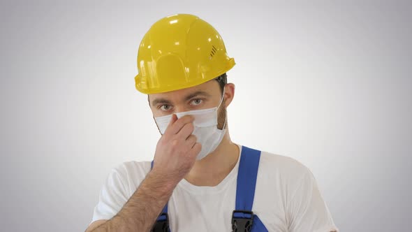 Ware the Mask! Masked Construction Man in Hardhat on Gradient Background alt