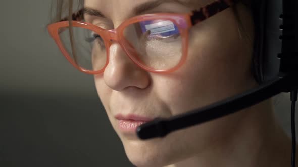 Closeup Portrait of Beautiful Serious Woman with Headphones and Microphone in Glasses Reflecting