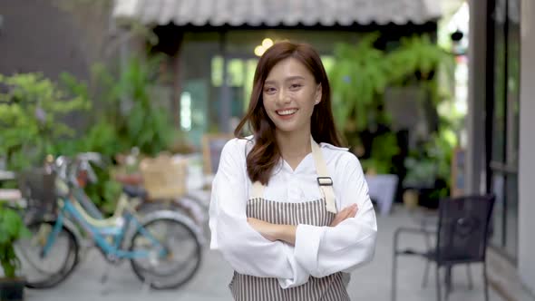 Successful small business young owner woman standing with looking at camera posing crossing arms alt