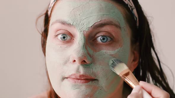 Beautiful Woman Applying Facial Mask on Her Face