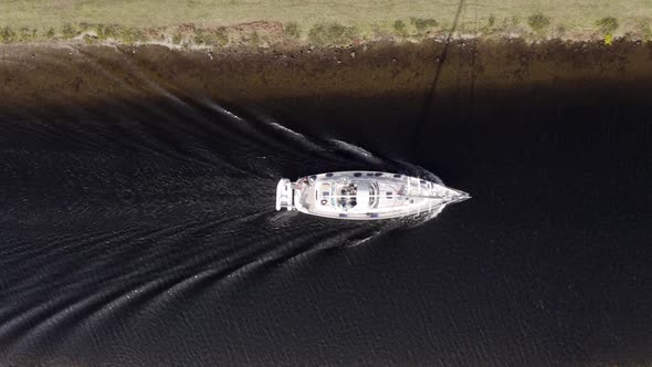 A Yacht Motoring Along a Canal Bird's Eye View alt