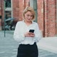 Woman Standing Near Modern Building Typing Text Messages on Smartphone at Nice Day. - VideoHive Item for Sale