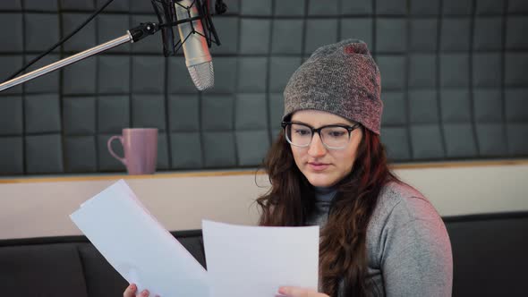 Voice artist works with material of some broadcast live show. Dubbing, voice over alt