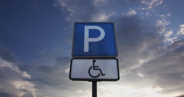 Disabled Parking Sign On A Background Of Clouds alt
