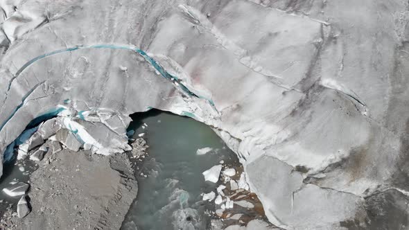 Aerial: terminus of glacier, end of glacier melting and breaking, global warming alt