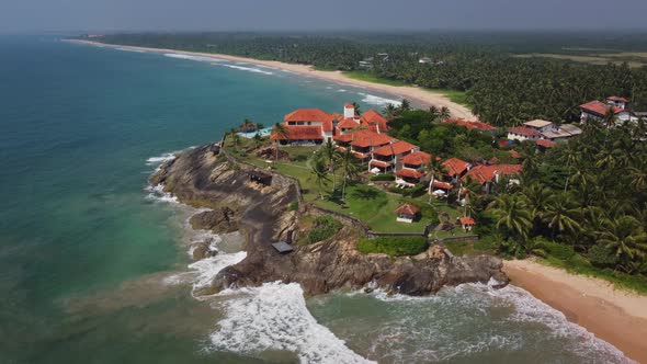 Travel to tropical resort. Luxurious hotel with a swimming pool on a rocky ocean shore. Paradise vac alt