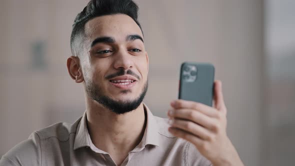 Happy Young Arabian Guy Business Man Male Worker Hold Smartphone Talk By Video Call Greeting Have alt