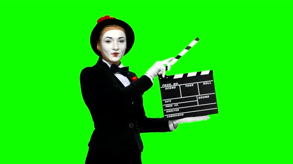Woman Mime Uses the Movie Clapper on Green Screen alt