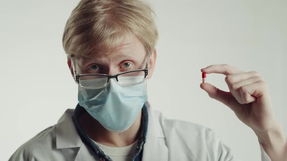 Caucasian Man Doctor Holding Pills on White Background Student of Medical University Portrait Young alt