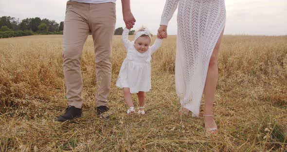 Young Parents Teach Their Baby To Walk