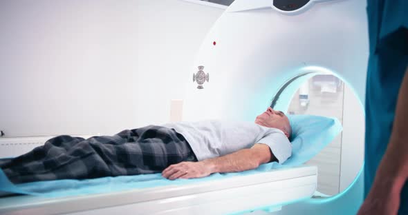 Senior Patient Asking Questions To Crop Doctor After CT Scanning alt