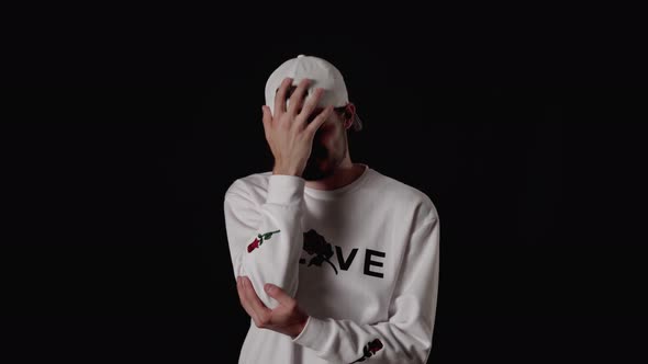 Trendy 20s Man shaking head giving extreme facepalm, wide, black background alt