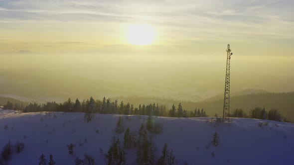 Flying Over Radio Communications Tower Mountain Snow Covered Winter Landscape alt