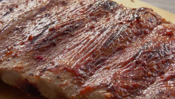 Super Closeup of the Juicy Delicious Ribs Spread with Tomato Sauce alt